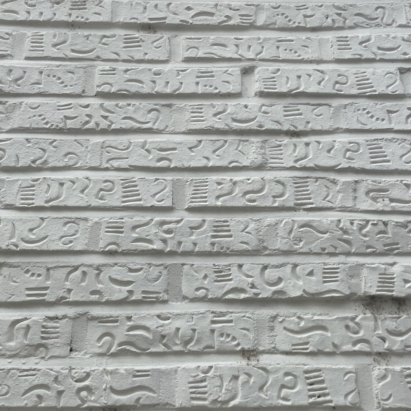 white brick wall with interesting carved patterns