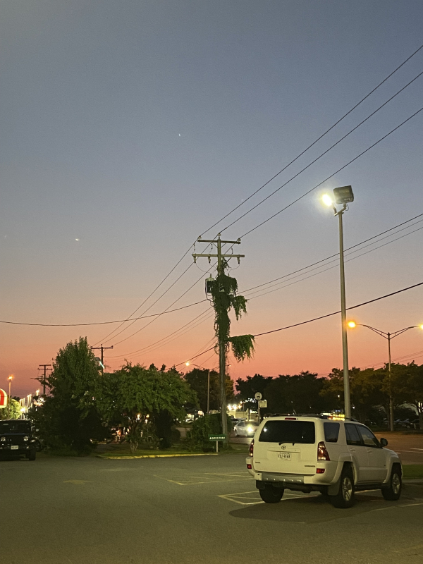 a sunset scene at a parking lot
