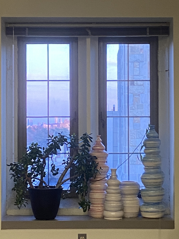 ceramic vases infront of a window