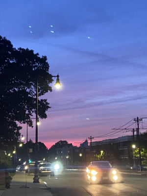 a purple and pink sunset on a busy road